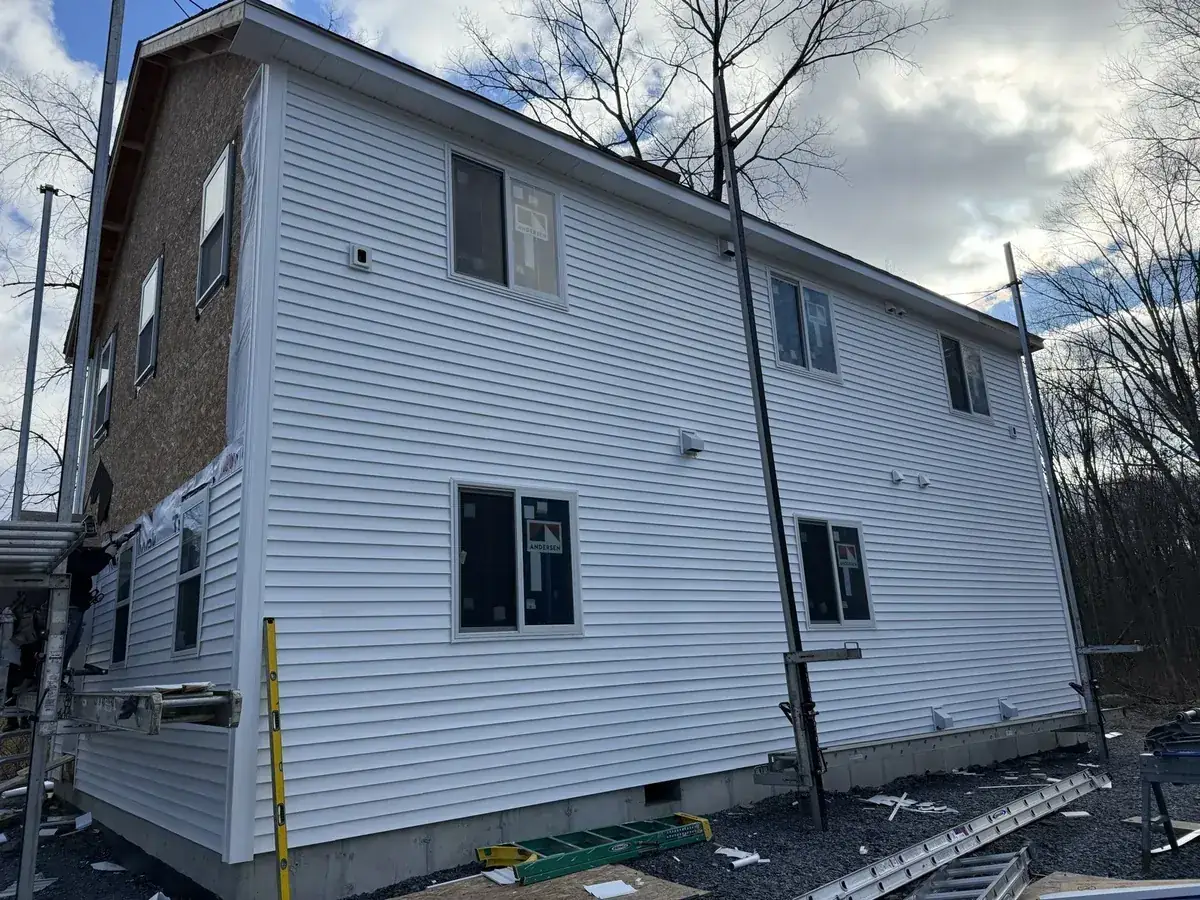 New white siding installed on a two-story home in Gardiner, NY